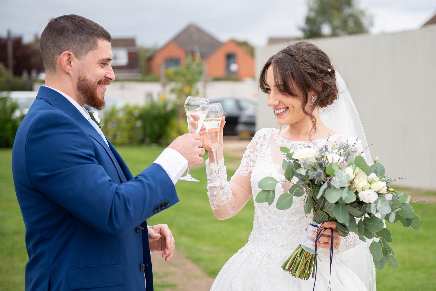 Bride and groom laughing with drinks